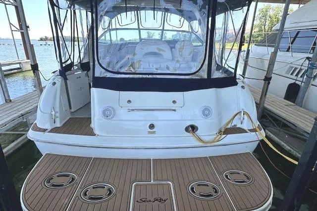 Slide: The Image of 2001 Sea Ray 380 Sundancer docked, showcasing spacious deck and elegant design. - 5