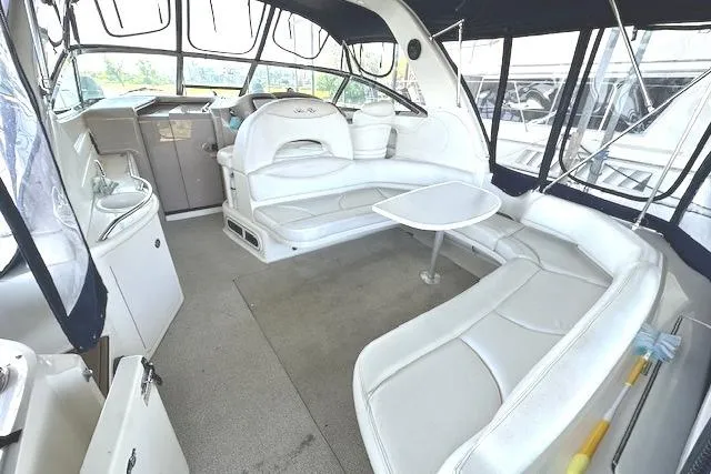 Slide: The Image of 2001 Sea Ray 380 Sundancer interior with white seating and table. - 6
