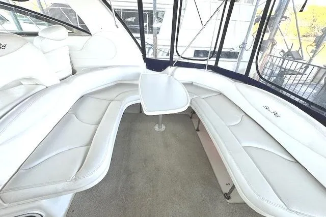 Slide: The Image of Luxurious interior of 2001 Sea Ray 380 Sundancer with white seating and table. - 7