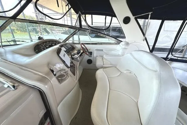 Slide: The Image of Interior of 2001 Sea Ray 380 Sundancer boat with white leather seating and control panel. - 8
