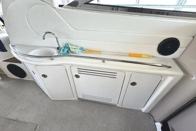 Slide: The Image of 2001 Sea Ray 380 Sundancer boat interior with sink and storage cabinets. - 9