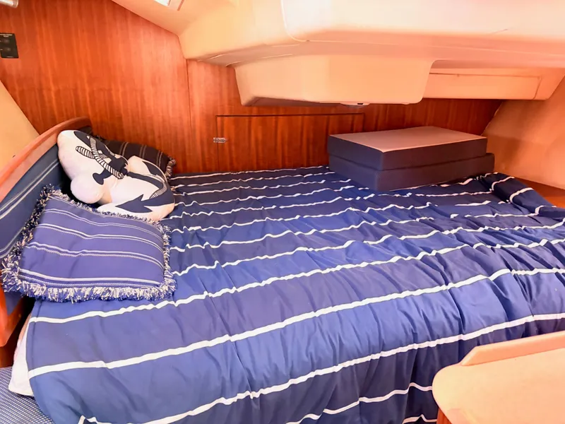 Slide: The Image of Interior of a 2006 Hunter 38 yacht, bed with blue bedding. - 16