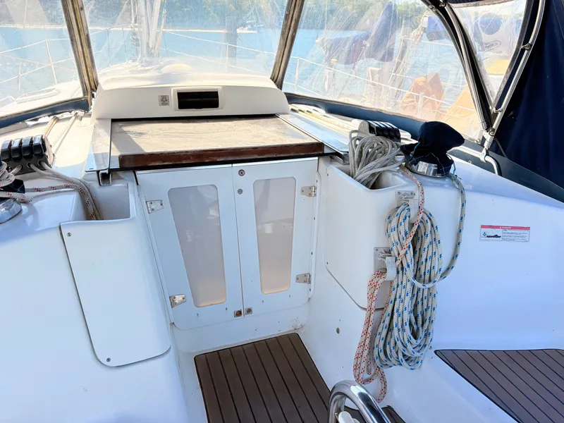 Slide: The Image of Interior of a 2006 Hunter 38 sailboat with ropes and helm area. - 7