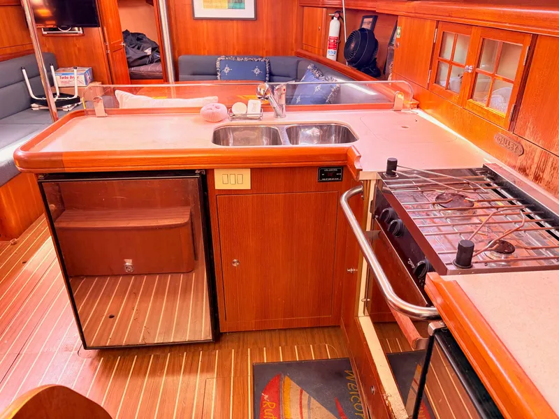Slide: The Image of Interior of a 2006 Hunter 38 yacht with kitchen and seating area. - 9