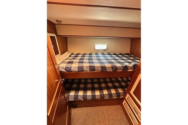 Slide: The Image of Bunk beds in 1987 Hi-Star 48 Yachtfish cabin with checkered bedding. - 4
