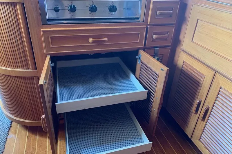 Slide: The Image of Wooden kitchen cabinetry with open drawers in a 1987 Hi-Star 48 Yachtfish. - 5