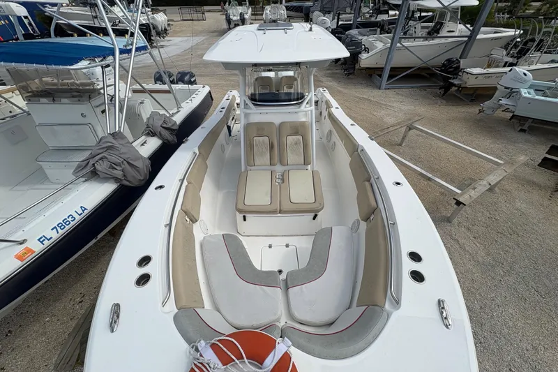 Slide: The Image of 2017 Sea Fox 288 Commander boat with spacious seating, docked among other vessels. - 11