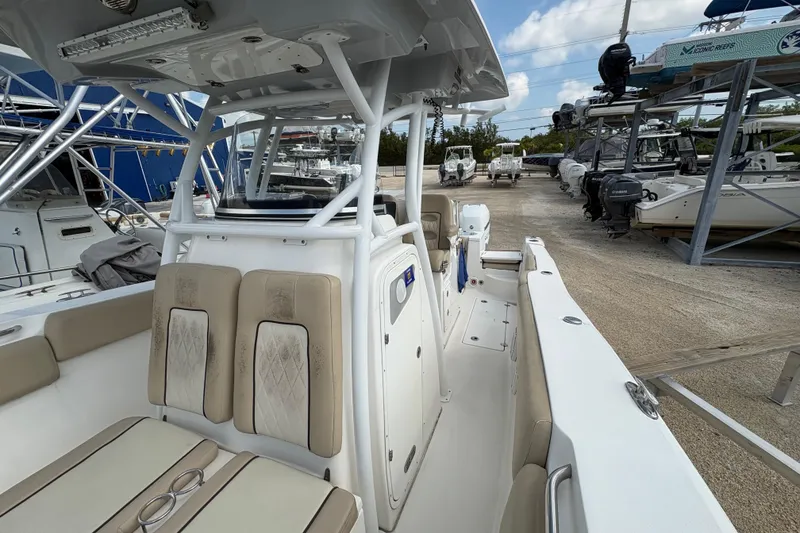 Slide: The Image of 2017 Sea Fox 288 Commander boat interior with seating and helm, docked in a marina. - 13