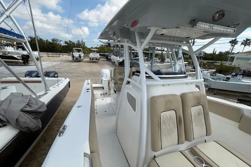 Slide: The Image of 2017 Sea Fox 288 Commander boat with beige seating, parked in a marina. - 14