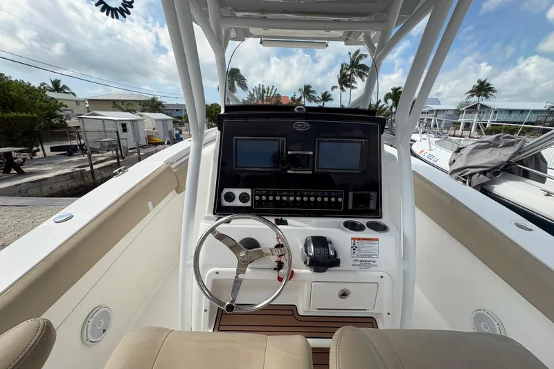 Slide: The Image of 2017 Sea Fox 288 Commander boat dashboard with steering wheel and navigation screens. - 17