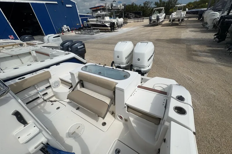 Slide: The Image of 2017 Sea Fox 288 Commander boat with dual Mercury engines, docked at a marina. - 19