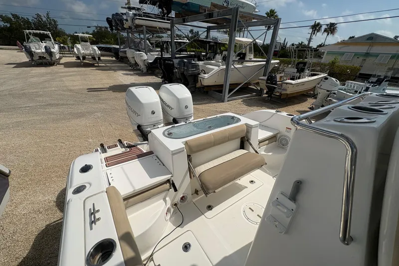 Slide: The Image of 2017 Sea Fox 288 Commander boat with dual engines in a marina setting. - 20