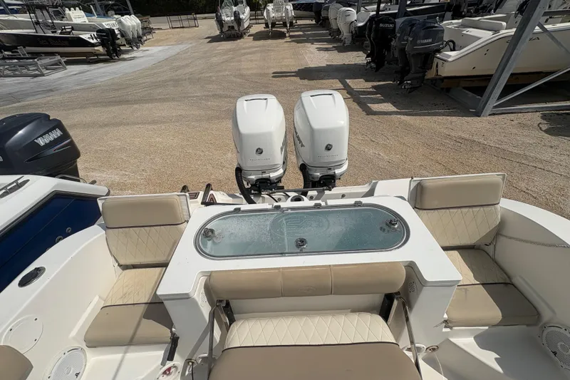 Slide: The Image of 2017 Sea Fox 288 Commander boat with dual engines and seating area in a marina. - 22
