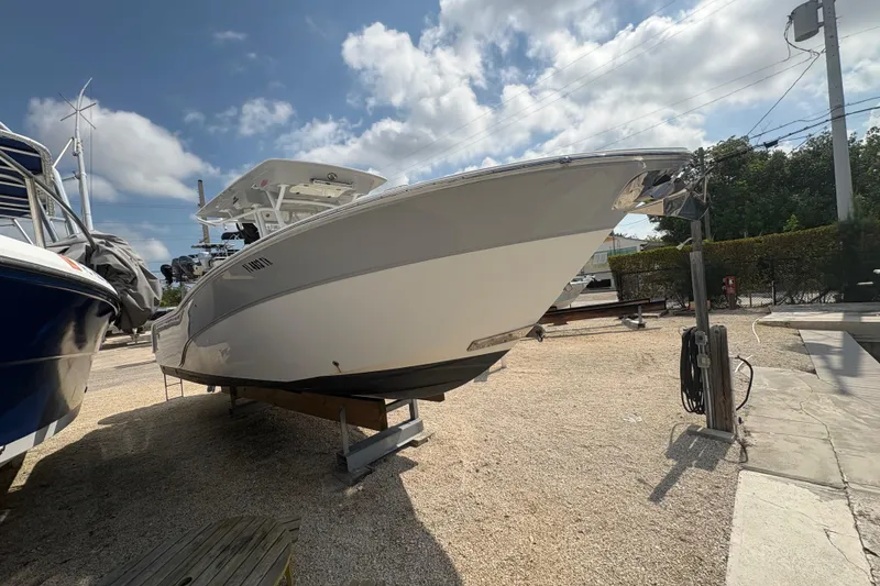 Slide: The Image of 2017 Sea Fox 288 Commander boat on dry dock under a partly cloudy sky. - 4