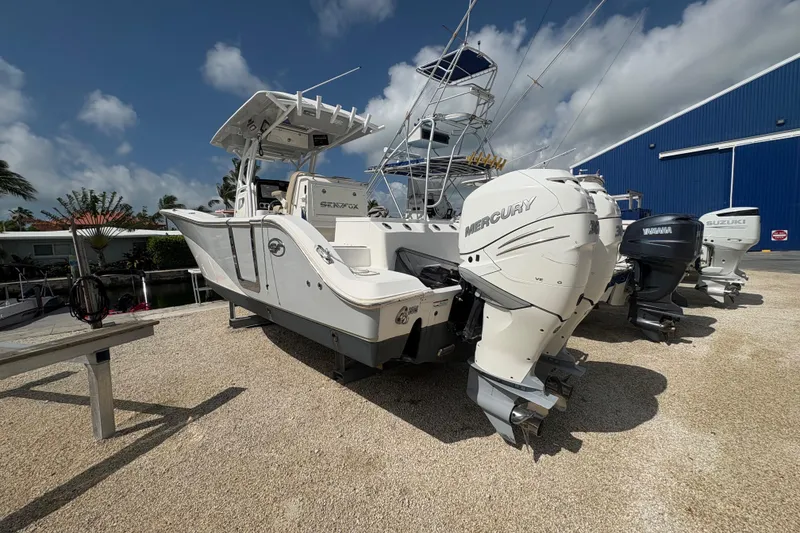 Slide: The Image of 2017 Sea Fox 288 Commander boat with Mercury outboard engines, parked outdoors. - 6