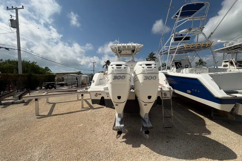 Slide: The Image of 2017 Sea Fox 288 Commander boat with twin 300 horsepower engines, parked outdoors. - 7