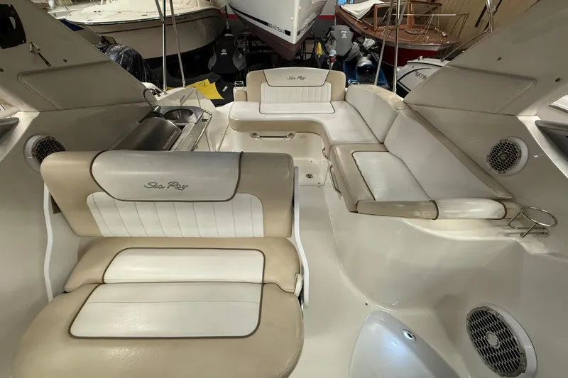 Slide: The Image of Interior of a 2012 Sea Ray Sundancer 280 boat with beige seating and built-in speakers. - 11