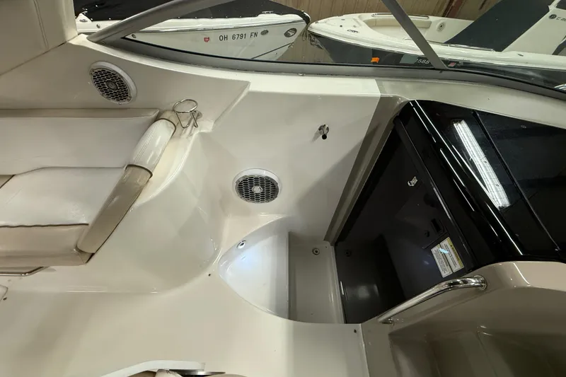 Slide: The Image of Interior view of a 2012 Sea Ray Sundancer 280 boat, featuring seating and cabin entrance. - 12