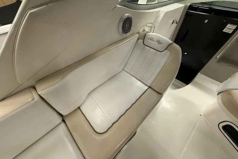 Slide: The Image of Interior seating of 2012 Sea Ray Sundancer 280 boat, featuring beige and white upholstery. - 13