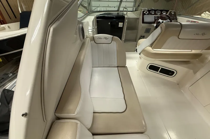 Slide: The Image of Interior of a 2012 Sea Ray Sundancer 280 boat, featuring beige seating and helm. - 14