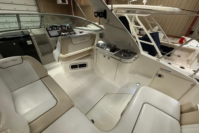 Slide: The Image of Interior of 2012 Sea Ray Sundancer 280 boat with seating and kitchenette area. - 16