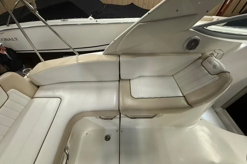 Slide: The Image of Interior seating of 2012 Sea Ray Sundancer 280 boat, featuring white and beige upholstery. - 18