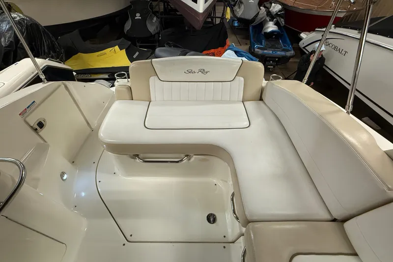 Slide: The Image of Interior seating of a 2012 Sea Ray Sundancer 280 boat, featuring white upholstery. - 19