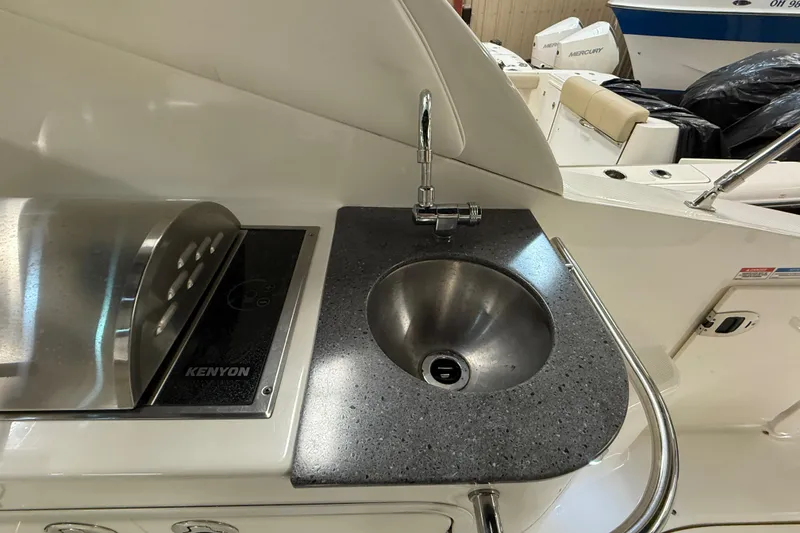 Slide: The Image of Outdoor kitchenette on 2012 Sea Ray Sundancer 280 with sink and Kenyon grill. - 21