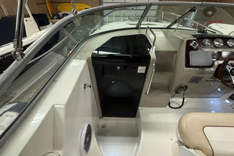 Slide: The Image of 2012 Sea Ray Sundancer 280 cockpit with helm, seating, and control panel. - 24