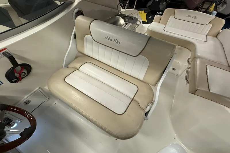 Slide: The Image of Interior seating of a 2012 Sea Ray Sundancer 280 boat, featuring beige and white upholstery. - 27