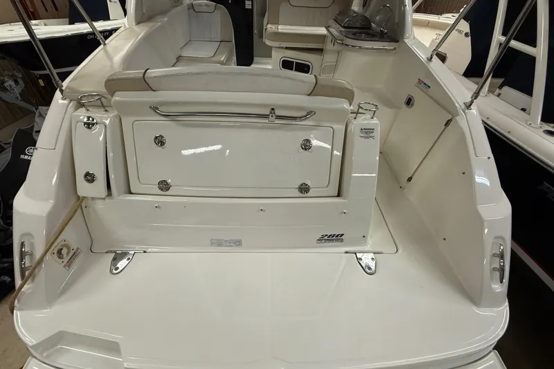 Slide: The Image of 2012 Sea Ray Sundancer 280 boat interior, featuring sleek white seating and storage compartments. - 3