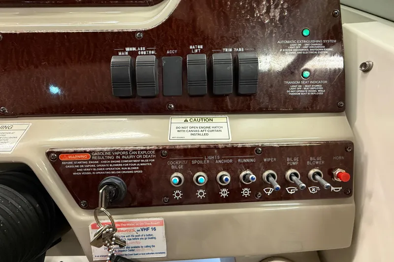 Slide: The Image of Control panel of a 2012 Sea Ray Sundancer 280 boat with switches and warning labels. - 31