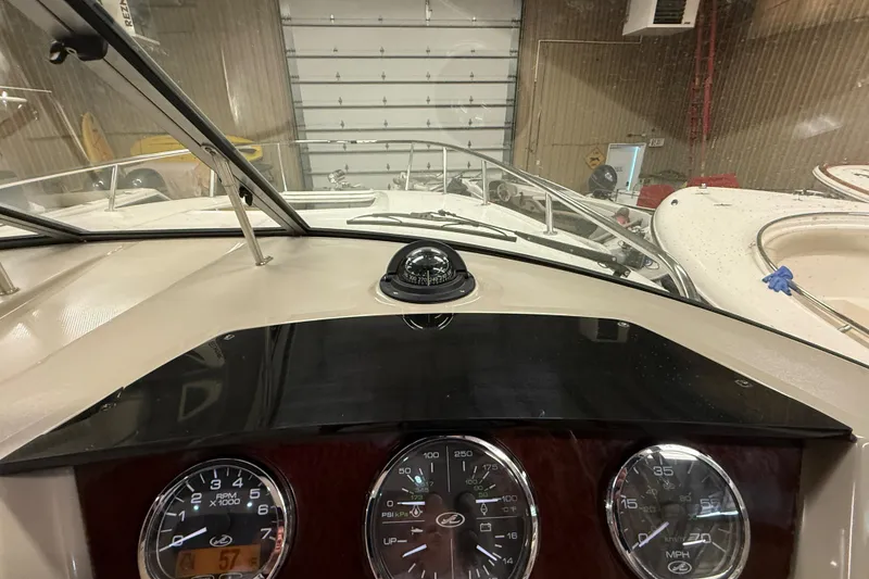 Slide: The Image of Dashboard view of a 2012 Sea Ray Sundancer 280 boat in a garage setting. - 33