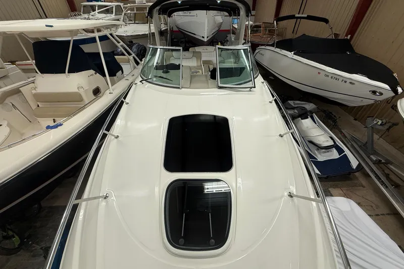 Slide: The Image of 2012 Sea Ray Sundancer 280 boat in storage, surrounded by other vessels. - 40