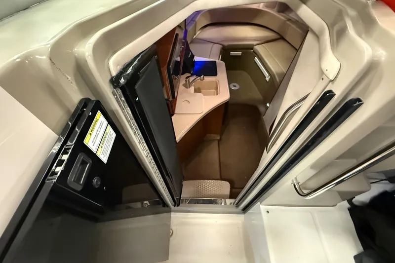 Slide: The Image of Interior view of 2012 Sea Ray Sundancer 280 cabin with kitchenette and seating area. - 42