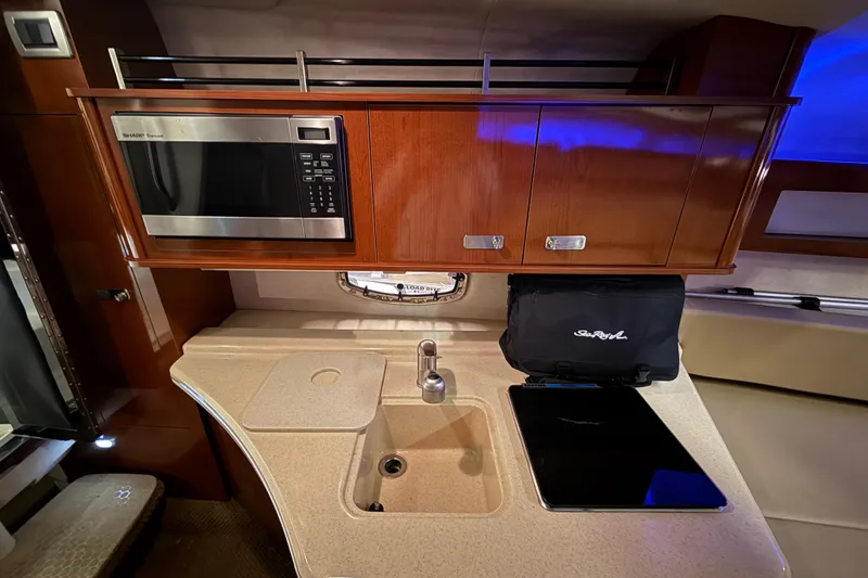 Slide: The Image of Luxurious 2012 Sea Ray Sundancer 280 galley with microwave, sink, and storage cabinets. - 47