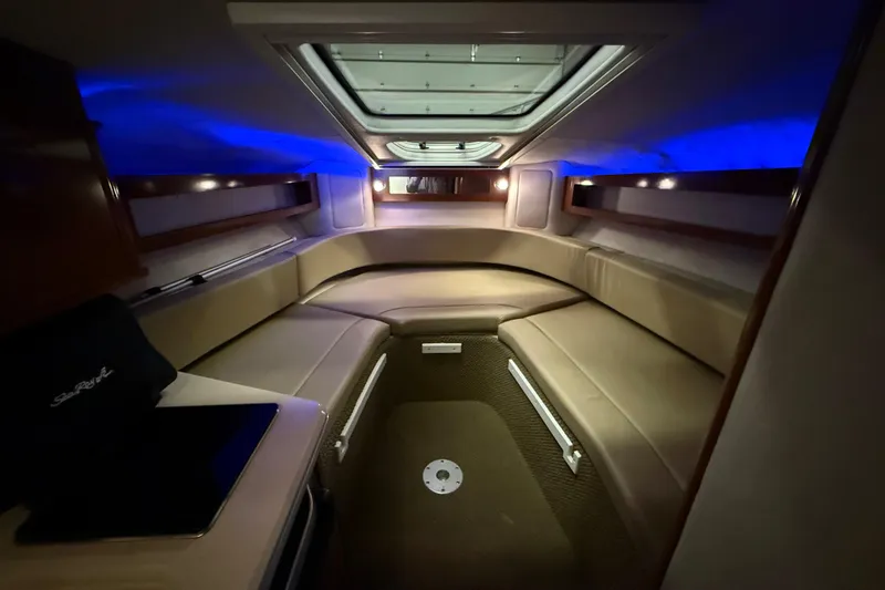 Slide: The Image of Interior of 2012 Sea Ray Sundancer 280 with ambient blue lighting and cozy seating. - 48