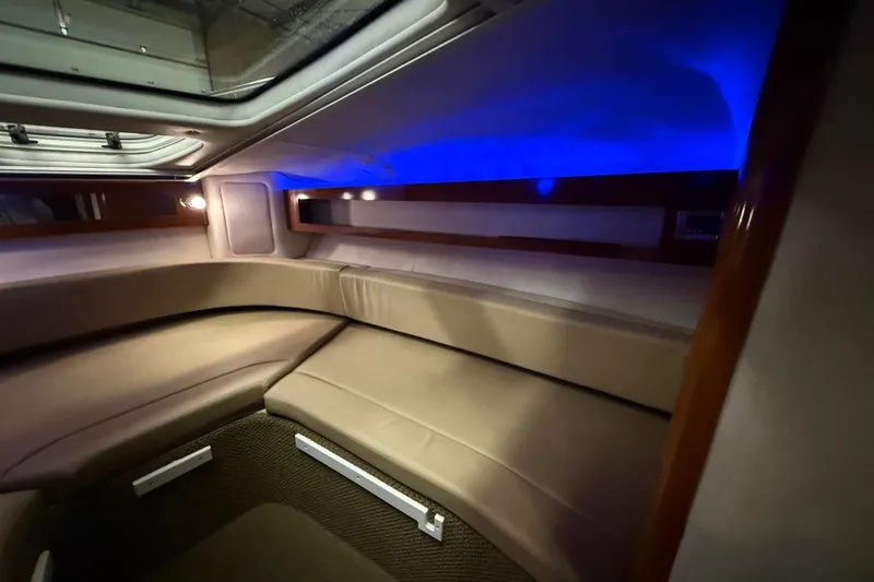 Slide: The Image of Interior of 2012 Sea Ray Sundancer 280 with blue ambient lighting and plush seating. - 49