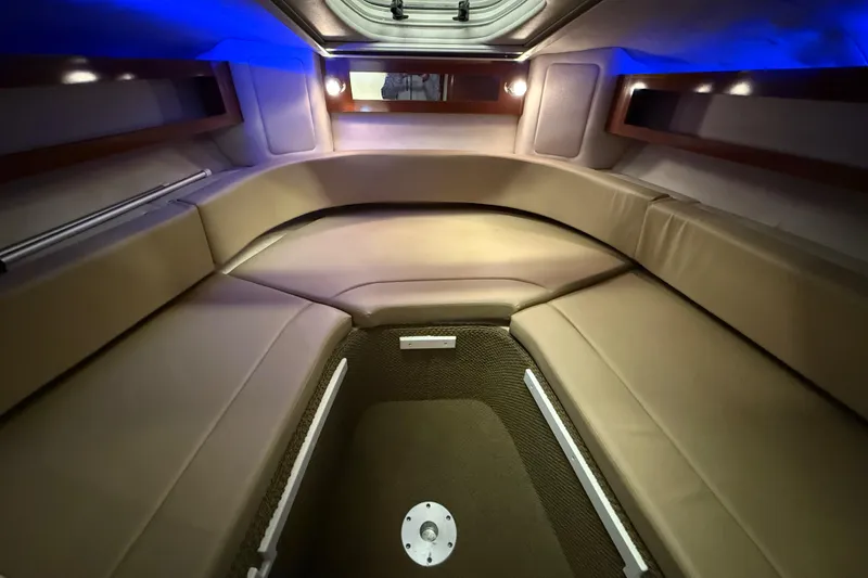 Slide: The Image of Interior cabin of 2012 Sea Ray Sundancer 280 with plush seating and ambient lighting. - 51