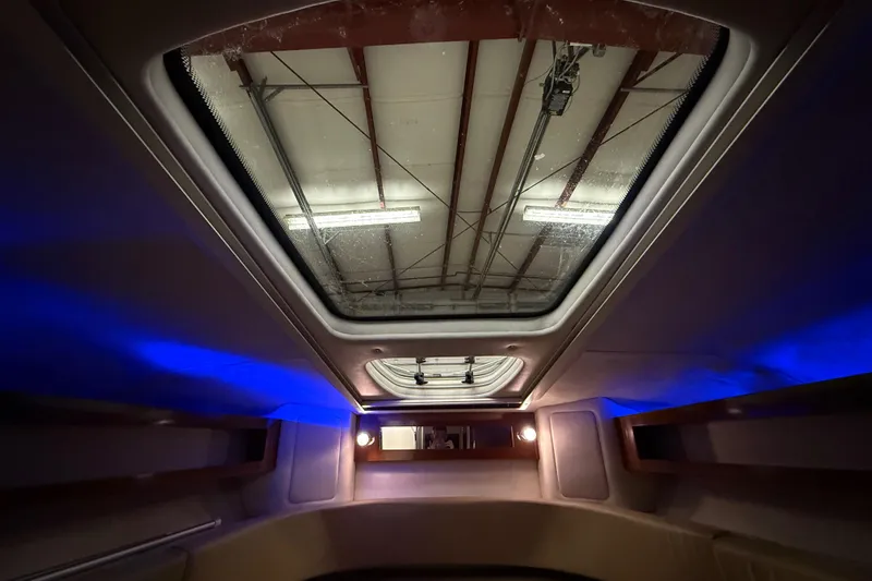 Slide: The Image of Interior view of 2012 Sea Ray Sundancer 280 with skylight and ambient blue lighting. - 52