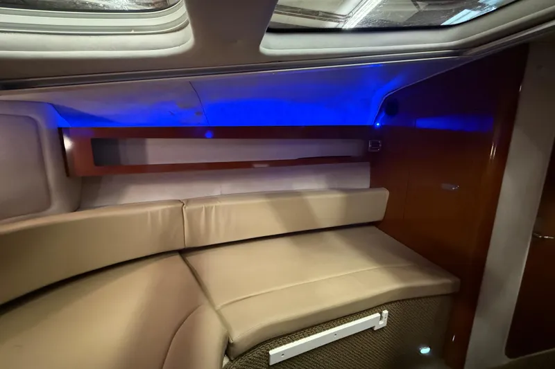 Slide: The Image of Interior of 2012 Sea Ray Sundancer 280 with beige seating and blue ambient lighting. - 53