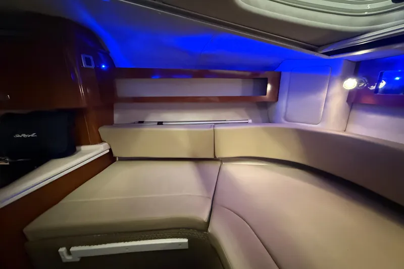 Slide: The Image of Interior cabin of 2012 Sea Ray Sundancer 280 with blue ambient lighting. - 54