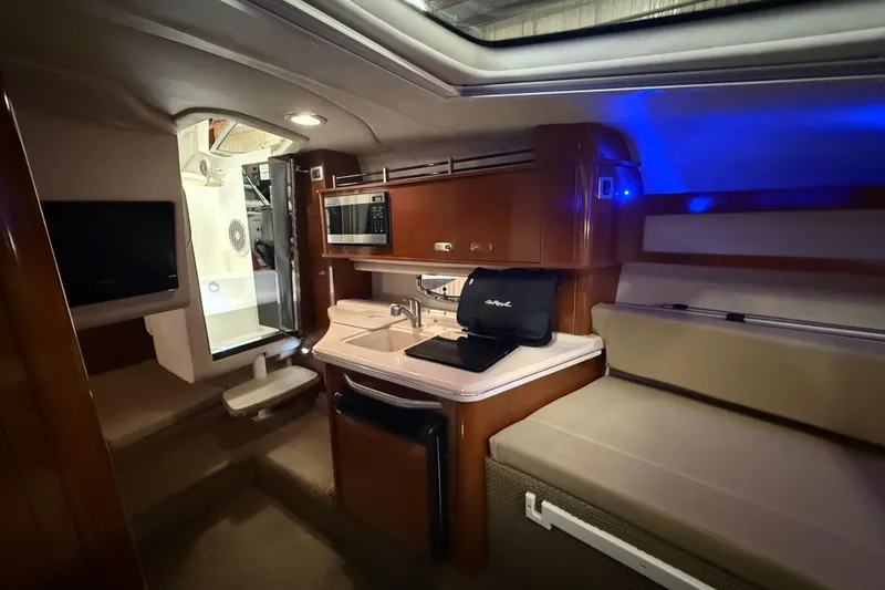 Slide: The Image of Interior of 2012 Sea Ray Sundancer 280 yacht with kitchenette and seating area. - 55