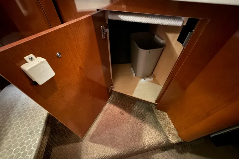 Slide: The Image of Open cabinet with trash bin inside Sea Ray Sundancer 280, 2012 model. - 63