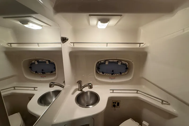Slide: The Image of Interior of 2012 Sea Ray Sundancer 280 bathroom with sink and porthole window. - 67