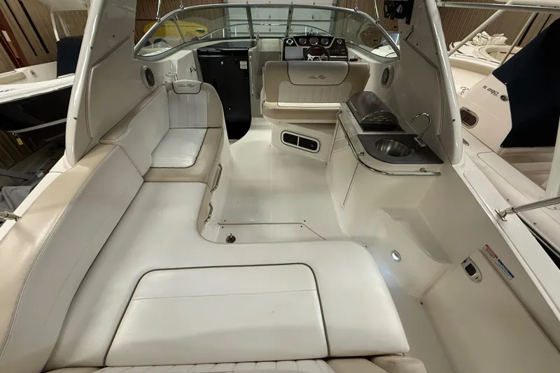 Slide: The Image of 2012 Sea Ray Sundancer 280 interior with seating, sink, and helm. - 7