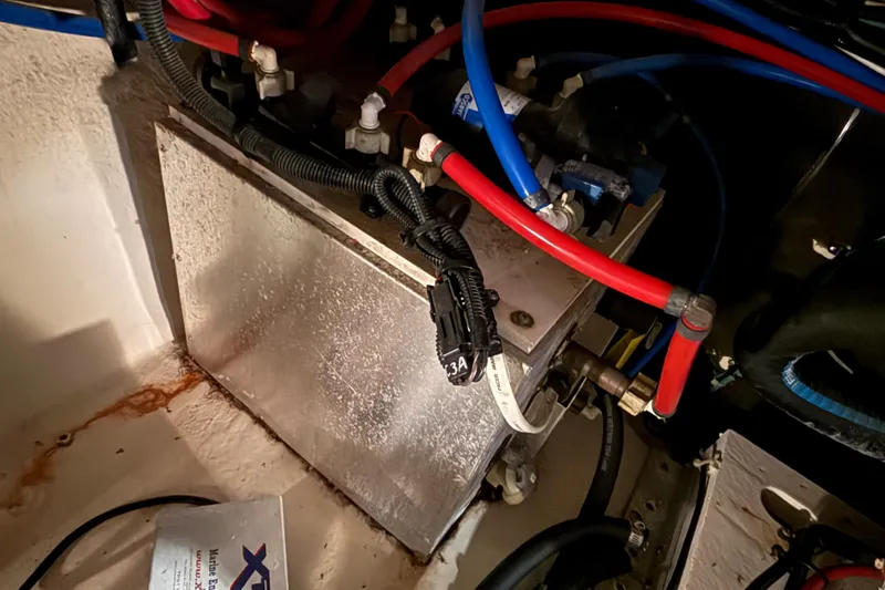 Slide: The Image of Engine compartment of a 2012 Sea Ray Sundancer 280 with wiring and components visible. - 76