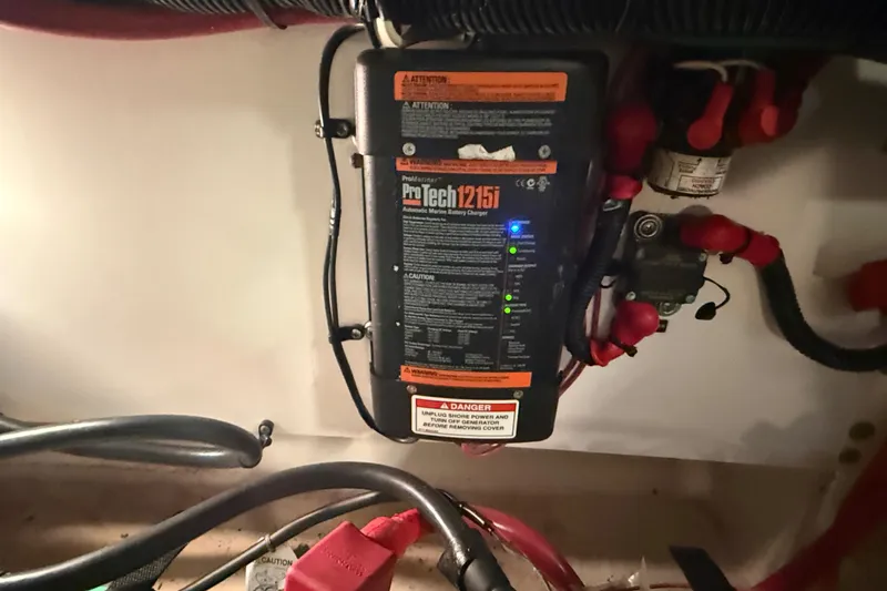 Slide: The Image of Battery charger setup in a 2012 Sea Ray Sundancer 280 boat engine compartment. - 77