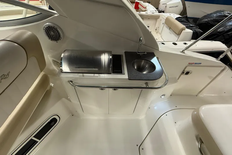 Slide: The Image of 2012 Sea Ray Sundancer 280 boat interior with sink and grill in cockpit area. - 8