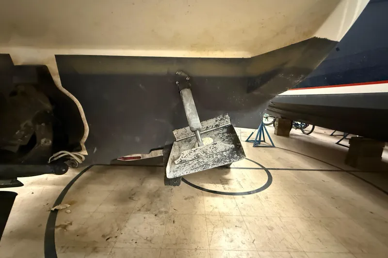 Slide: The Image of 2012 Sea Ray Sundancer 280 boat hull with trim tab in storage. - 80